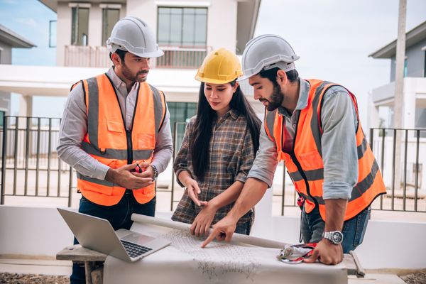 Engineers reviewing construction blueprints